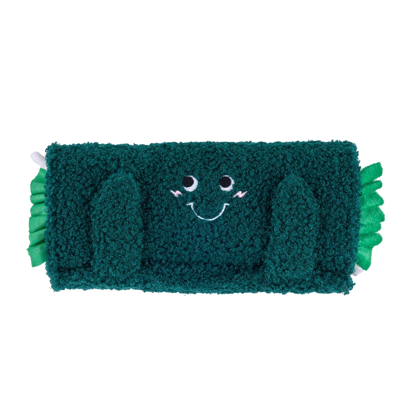 Green plush toy with a smiling face on a white background