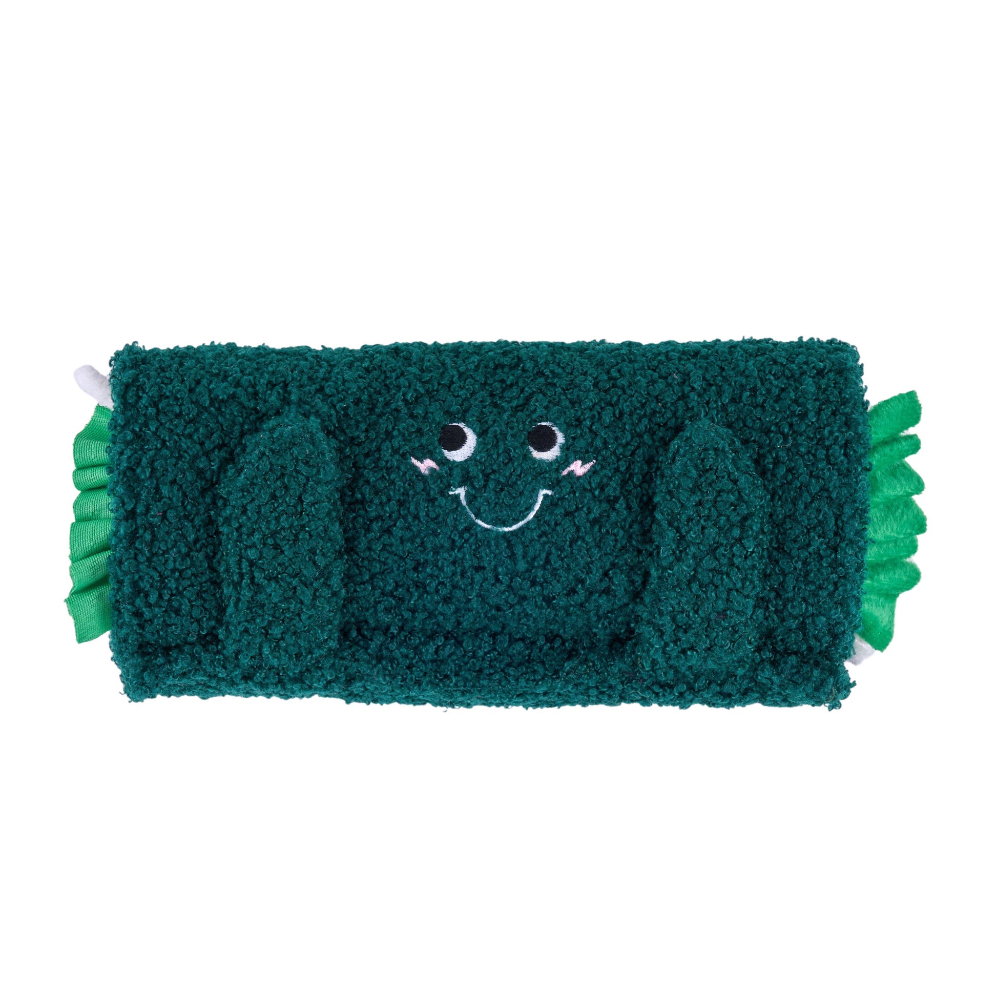 Green plush toy with a smiling face on a white background